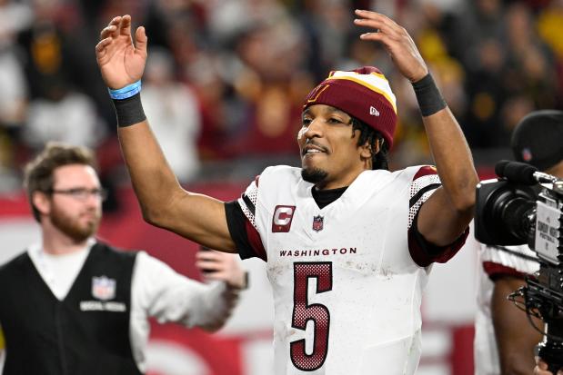 Commanders quarterback Jayden Daniels celebrates after a wild-card win against the Buccaneers in Tampa, Fla., on Jan. 12, 2025. (AP Photo/Jason Behnken)