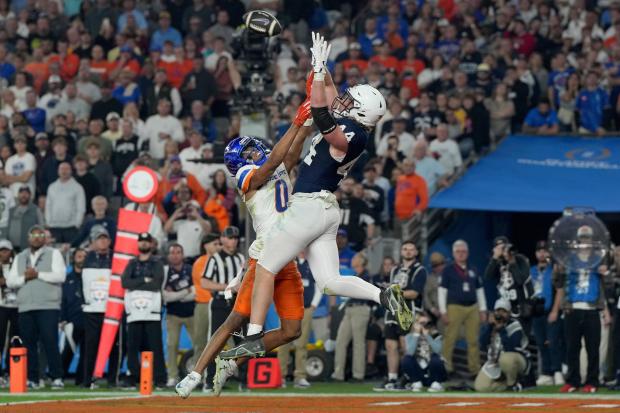 Penn State tight end Tyler Warren pulls in a touchdown pass as Boise State safety Ty Benefield defends during the Fiesta Bowl on Dec. 31, 2024, in Glendale, Ariz. (AP Photo/Rick Scuteri)