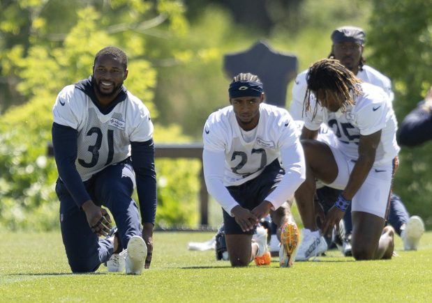 Bears safety Kevin Byard (31), cornerback Greg Stroman (27) and other defensive players stretch out during minicamp at Halas Hall on June 6, 2024, in Lake Forest. (Stacey Wescott/Chicago Tribune)