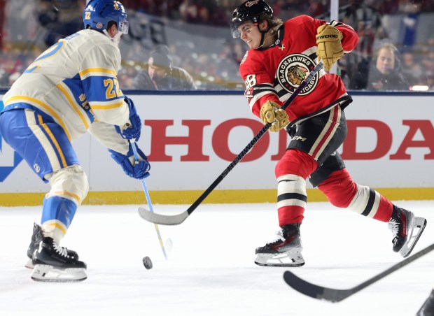 Blackhawks center Connor Bedard passes the puck as Blues defenseman Ryan Suter defends in the third period of the NHL Winter Classic at Wrigley Field on Dec. 31, 2024. (John J. Kim/Chicago Tribune)