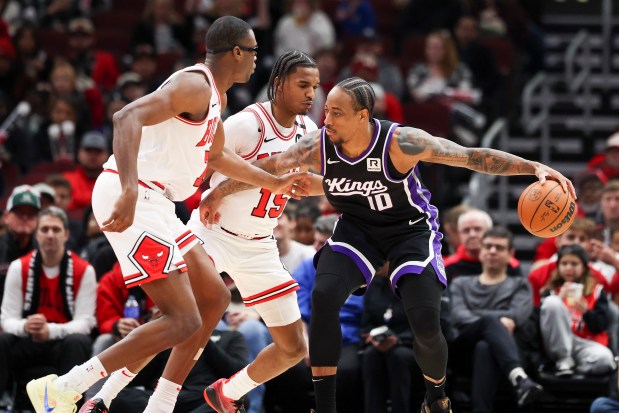 Sacramento Kings forward DeMar DeRozan (10) protects the ball from Chicago Bulls forward Jalen Smith (7) and Chicago Bulls forward Julian Phillips (15) during the first quarter at the United Center on Sunday, Jan. 12, 2025. (Eileen T. Meslar/Chicago Tribune)