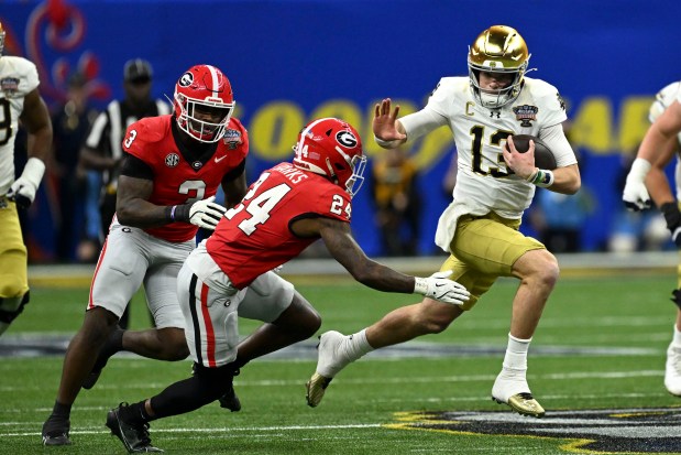 Notre Dame quarterback Riley Leonard runs from Georgia defensive back Malaki Starks during the first half on Jan. 2, 2025, in New Orleans. (AP Photo/Matthew Hinton)