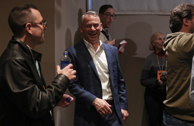 Cubs General Manager Jed Hoyer, center, laughs with reporters after taking questions at the Loews Chicago Downtown Hotel before the opening ceremony for the Cubs Convention at the Sheraton Grand Chicago Riverwalk on Jan. 17, 2025. (John J. Kim/Chicago Tribune)