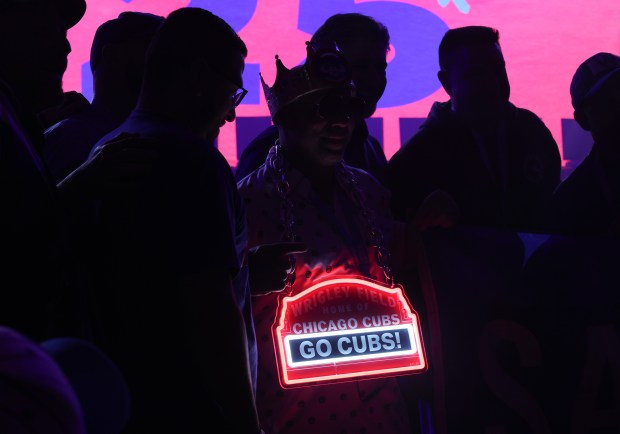 A Cubs fan wears an illuminated Wrigley Field marquee before the opening ceremony of the Cubs Convention at the Sheraton Grand Chicago Riverwalk on Jan. 17, 2025. (John J. Kim/Chicago Tribune)