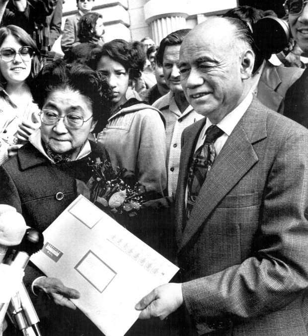 Iva Toguri D'Aquino, once known as Tokyo Rose, gives San Francisco postmaster Lim P. Lee an envelope addressed to President Ford, containing a petition for a presidential pardon in San Francisco in 1976. She was requesting that her American citizenship, stripped from her by her treason conviction in 1949, be restored to her. (UPI)