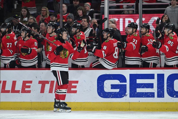 Blackhawks' Tyler Bertuzzi celebrates with teammates at the bench after scoring a goal during the first period against the Canadiens on Jan. 3, 2025. (AP Photo/Paul Beaty)