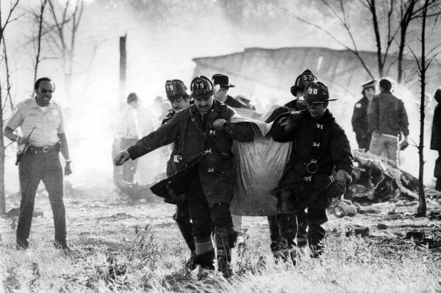 Firefighters and rescue teams set out to find the remains of victims amid the smoldering debris from American Airlines Flight 191 accident at O'Hare International Airport in May 1979. (Val Mazzenga/Chicago Tribune)