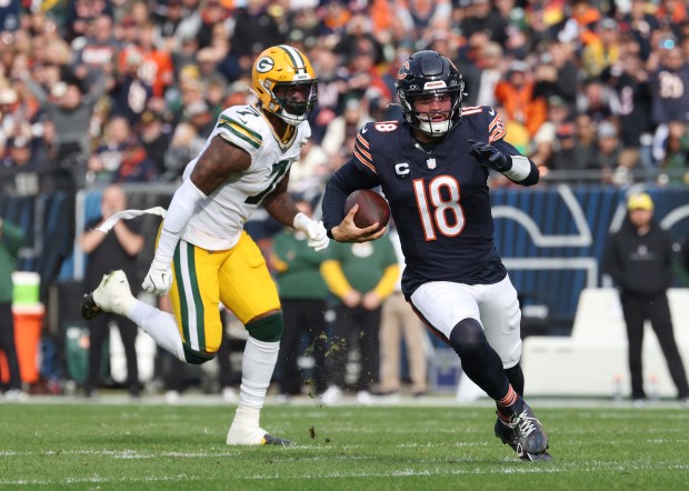 Bears quarterback Caleb Williams runs from Packers linebacker Quay Walker on Nov. 17, 2024, at Soldier Field. (John J. Kim/Chicago Tribune)