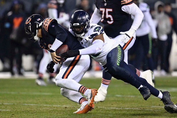 The Seahawks' Uchenna Nwosu sacks Bears quarterback Caleb Williams on Dec. 26, 2024, at Soldier Field. (Quinn Harris/Getty Images)