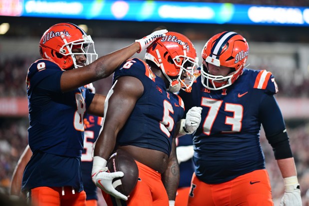 Illinois running back Josh McCray celebrates with Malik Elzy (8) and Josh Gesky (73) after scoring in the fourth quarter against South Carolina during the Citrus Bowl on Dec. 31, 2024, in Orlando, Fla. (Julio Aguilar/Getty Images)