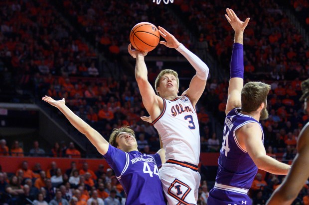 Illinois' Ben Humrichous goes to the basket past Northwestern's Angelo Ciaravino, left, on Sunday, Jan. 26, 2025, in Champaign. (AP Photo/Craig Pessman)