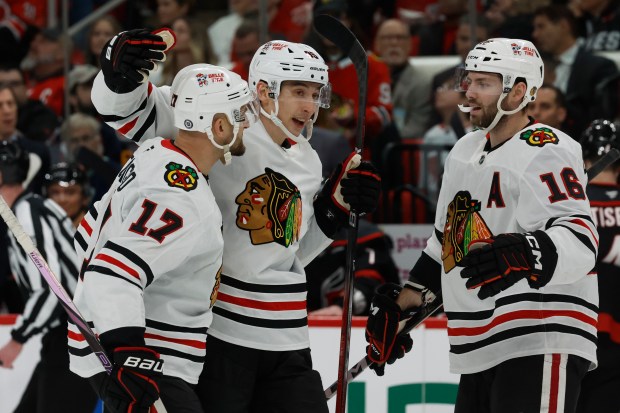 The Blackhawks' Connor Bedard celebrates his goal against the Hurricanes with teammates Nick Foligno (17) and Jason Dickinson (16) during the second period Thursday, Jan. 30, 2025, in Raleigh, N.C. (AP Photo/Karl DeBlaker)