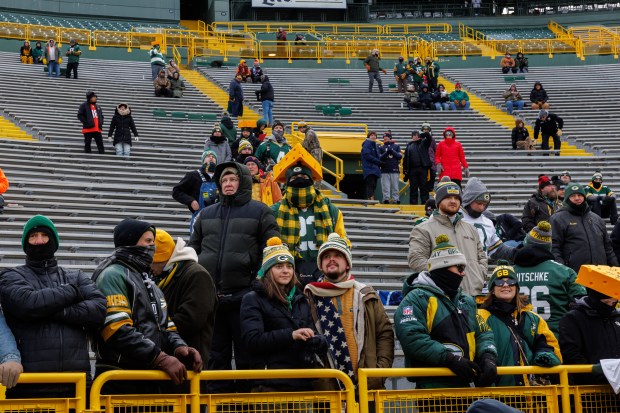 Fans watch players warm up before the Chicago Bears play the Green Bay Packers in Green Bay. (Armando L. Sanchez/Chicago Tribune)