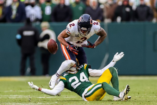 Chicago Bears wide receiver DJ Moore (2) fumbles the ball before its recovered by Green Bay Packers safety Javon Bullard (20) during the fourth quarter at Lambeau Field Sunday Jan. 5, 2025, in Green Bay, Wis. (Armando L. Sanchez/Chicago Tribune)