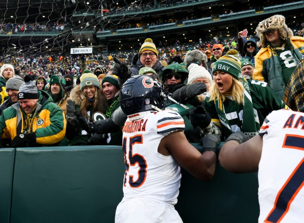 Green Bay Packers fans push yell at Bears linebacker Amen Ogbongbemiga (45) as he celebrates Cairo Santos' game-winning 51-yard field goal against the Green Bay Packers at Lambeau Field on Sunday. (Eileen T. Meslar/Chicago Tribune)