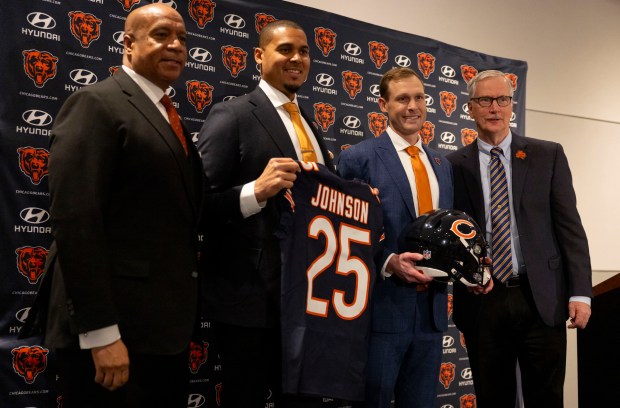 New Bears coach Ben Johnson takes pictures with team president Kevin Warren, general manager Ryan Poles and chairman George McCaskey after being introduced on Jan. 22, 2025, at Halas Hall. (Brian Cassella/Chicago Tribune)