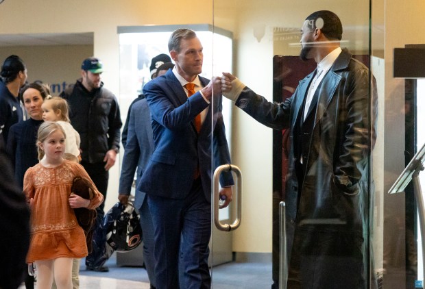 New Bears coach Ben Johnson greets quarterback Caleb Williams before being introduced on Jan. 22, 2025, at Halas Hall. (Brian Cassella/Chicago Tribune)