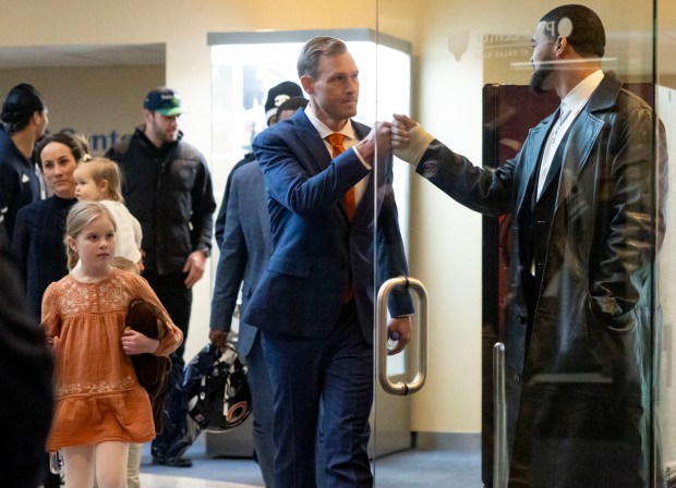 New Chicago Bears head coach Ben Johnson greets quarterback Caleb Williams before being introduced on Wednesday at Halas Hall. After interviewing 17 candidates over 12 days, the Bears hired the former Detroit Lions offensive coordinator.(Brian Cassella/Chicago Tribune)