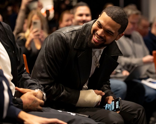 Quarterback Caleb Williams sits with some teammates as new Chicago Bears coach Ben Johnson is introduced Wednesday, Jan. 22, 2025, at Halas Hall. (Brian Cassella/Chicago Tribune)