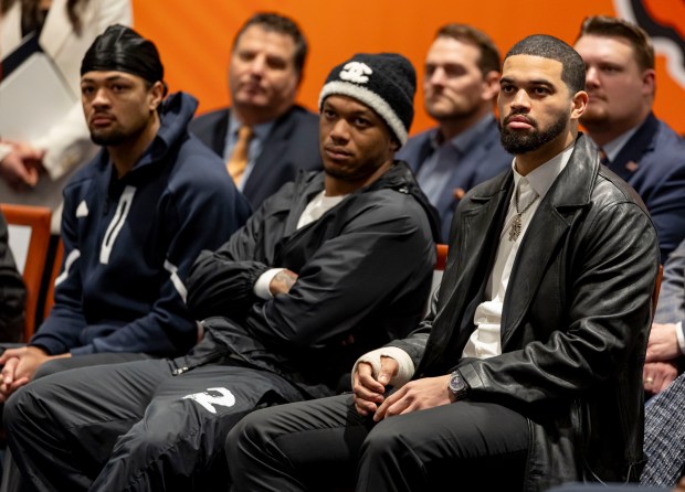 Bears players Rome Odunze, DJ Moore and Caleb Williams listen as new Chicago Bears coach Ben Johnson speaks Wednesday, Jan. 22, 2025, at Halas Hall. (Brian Cassella/Chicago Tribune)