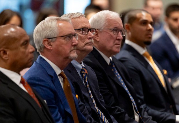 Team president Kevin Warren, Brian McCaskey, chairman George McCaskey, Patrick McCaskey and general manager Ryan Poles listen as new Chicago Bears coach Ben Johnson speaks after being introduced Wednesday, Jan. 22, 2025, at Halas Hall. (Brian Cassella/Chicago Tribune)