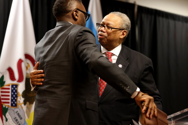 Mayor Brandon Johnson hugs CTA President Dorval Carter Jr., after Carter spoke at the news conference and signing ceremony in Chicago on Jan. 10, 2025, for the Full Funding Grant Agreement, which pledges $1.973 billion for the CTA Red Line Extension Project. With this project, the CTA Red Line would finally be extended from 95th Street to 130th Street, fulfilling a promise made to the Far South Side nearly 60 years ago. (Antonio Perez/Chicago Tribune)