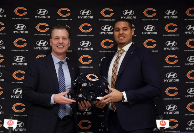 New Bears coach Matt Eberflus, left, and general manager Ryan Poles pose with a helmet after being introduced at a news conference on Jan. 31, 2022, at Halas Hall. (Brian Cassella/Chicago Tribune)