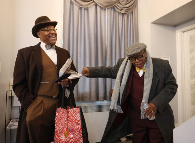 James 40X, left, jokes with Wilbur Muhammad after delivering bean pies for a funeral repass in Chicago on Nov. 23, 2024. (John J. Kim/Chicago Tribune)