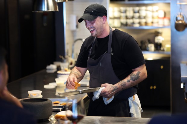 Chef/owner Norman Fenton talks to diners at the chef's counter at Cariño in Chicago, on Aug. 29, 2024. (Terrence Antonio James/Chicago Tribune)