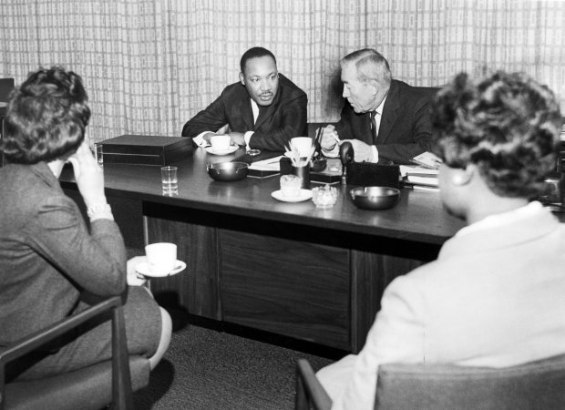 The Rev. Martin Luther King Jr. has coffee with Superintendent O.W. Wilson in Wilson's office after King spoke to police officials at a closed meeting on Jan. 27, 1966. Also attending were his wife, Coretta Scott King, left, and Dora MacDonald, right, King's secretary. (Chicago Tribune historical photo)