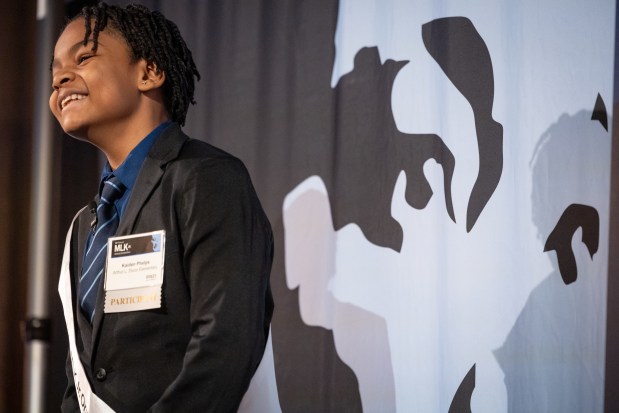 Kaiden Phelps of Arthur L. Dixon Elementary smiles when finishing his speech while competing for the top honor at Foley & Lardner LLP's Annual MLK Jr. Oratory Competition. (Audrey Richardson/Chicago Tribune)