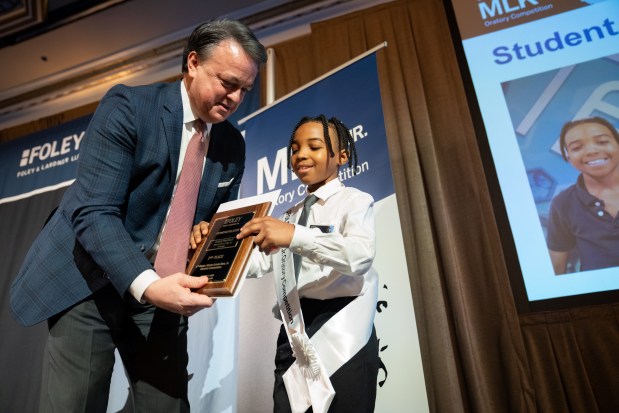 Aiden Marshall, of Boys and Girls Clubs of Chicago, right, is congratulated by Frank Pasquesi, a managing partner at Foley & Lardner LLP, at Lardner LLP's Annual MLK Jr. Oratory Competition. Marshall received second place in the competition. (Audrey Richardson/Chicago Tribune)