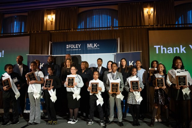 Judges and competitors pose for a photo at the end of Lardner LLP's Annual MLK Jr. Oratory Competition at The Drake Hotel Jan. 17, 2025. Harmony Daniels, of Wendell Smith Elementary, won the top honor after her captivating speech as the first contestant. (Audrey Richardson/Chicago Tribune)