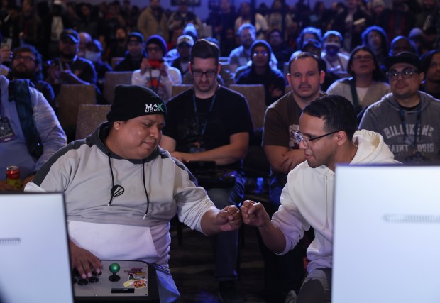 James Martinez, left, and David Thacker fist bump after competing against each other in the championship match of the Marvel vs. Capcom 2 video game tournament during Frosty Faustings XVII at the Westin Chicago Lombard on Jan. 24, 2025. (John J. Kim/Chicago Tribune)