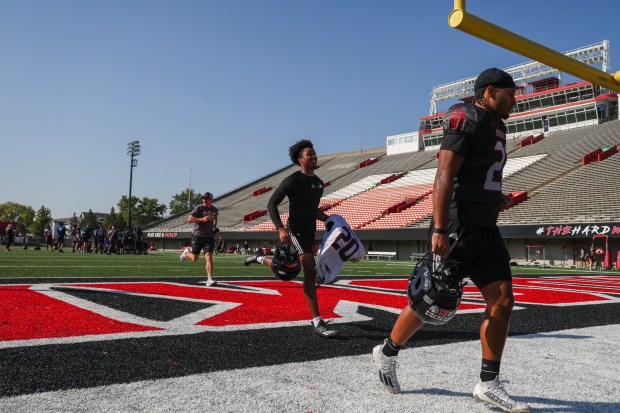 Northern Illinois football players jog off the field at the end of practice at Huskie Stadium in DeKalb on Sept. 17, 2024. (Eileen T. Meslar/Chicago Tribune)