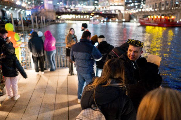 Jairo Gomez waits for the fireworks display along the Chicago River on New Year's Eve Dec. 31, 2024 in Chicago, Ill. (Vincent Alban/for The Chicago Tribune)