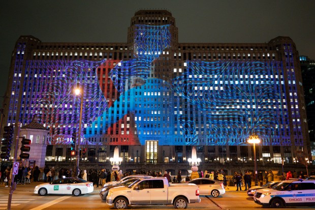 An ART on THE MART projection is displayed on the Merchandise Mart along the Chicago River on New Year's Eve Dec. 31, 2024 in Chicago. (Vincent Alban/for The Chicago Tribune)