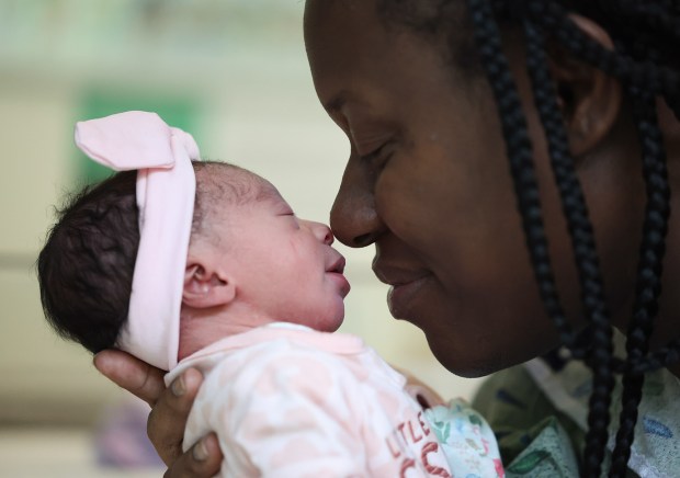 Ingrid Brandt snuggles with her new baby, Lavaeh Brandt, at Rush University Medical Center on Wednesday. Lavaeh was the first baby born at this hospital in 2025. (Stacey Wescott/Chicago Tribune)