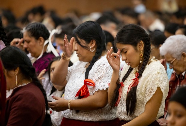 Parishioners pray during a Mass in honor of Nuestra Señora Virgen de la Nube, Our Lady of the Cloud, on New Year's Day, Jan. 1, 2025, at Our Lady of Mercy. (Brian Cassella/Chicago Tribune)