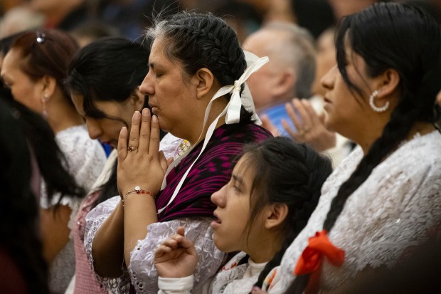 Parishioners pray during a Mass in honor of Nuestra Señora Virgen de la Nube, Our Lady of the Cloud, on Jan. 1, 2025, at Our Lady of Mercy on the Northwest Side. (Brian Cassella/Chicago Tribune)