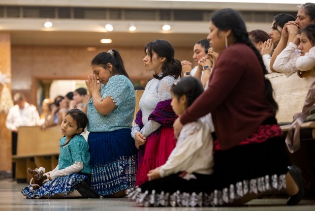 Parishioners pray during a Mass in honor of Nuestra Señora Virgen de la Nube, Our Lady of the Cloud, on New Year's Day, Jan. 1, 2025, at Our Lady of Mercy. (Brian Cassella/Chicago Tribune)