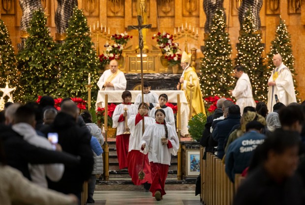 Parishioners finish a Mass in honor of Nuestra Señora Virgen de la Nube, Our Lady of the Cloud, on New Year's Day, Jan. 1, 2025, at Our Lady of Mercy on the Northwest Side. The Mass and processional through the Albany Park neighborhood are an annual Ecuadorian community celebration. (Brian Cassella/Chicago Tribune)