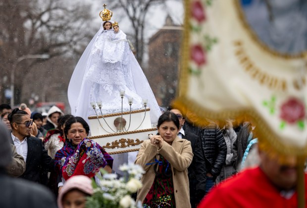 Parishioners carry a figure in honor of Nuestra Señora Virgen de la Nube, Our Lady of the Cloud, through the Albany Park on New Year's Day, Jan. 1, 2025, at Our Lady of Mercy on the Northwest Side. (Brian Cassella/Chicago Tribune)