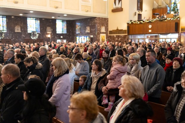 Parishioners stand during Mass on Jan. 5, 2025, at St. Ferdinand Church in Belmont Cragin before a Three Kings Parade down Belmont Avenue on the Northwest Side. The annual event marking the Epiphany mirrors celebrations held in Poland. (Brian Cassella/Chicago Tribune)