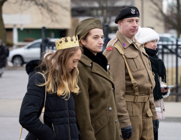 People in Polish military uniforms walk in a Three Kings Parade down Belmont Avenue on Jan. 5, 2025, from St. Ferdinand Church in Belmont Cragin on the Northwest Side. (Brian Cassella/Chicago Tribune)