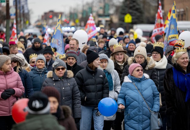 Parishioners walk in a Three Kings Parade down Belmont Avenue on Jan. 5, 2025, from St. Ferdinand Church in Belmont Cragin on the Northwest Side. The annual event marking the Epiphany mirrors celebrations held in Poland. (Brian Cassella/Chicago Tribune)