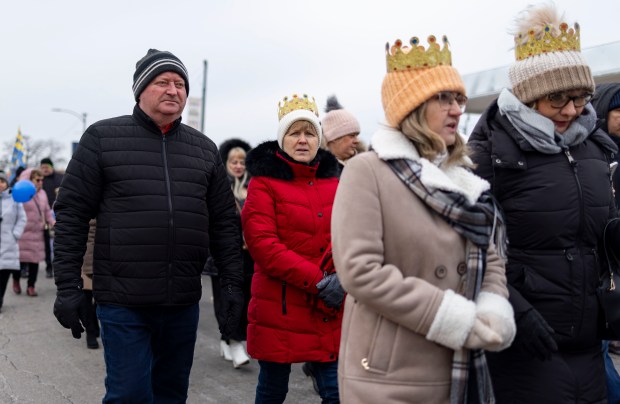 Parishioners walk in a Three Kings Parade down Belmont Avenue on Jan. 5, 2025, from St. Ferdinand Church in Belmont Cragin on the Northwest Side. (Brian Cassella/Chicago Tribune)