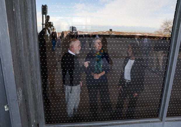 Paul Groleau, vice president of Feather Friendly, left, U.S. Fish and Wildlife Service Director Martha Williams and Metropolitan Pier & Exposition Authority CEO Larita Clark view the Feather Friendly glass treatment on the windows of McCormick Place Lakeside Center on Jan. 8, 2025. (Eileen T. Meslar/Chicago Tribune)