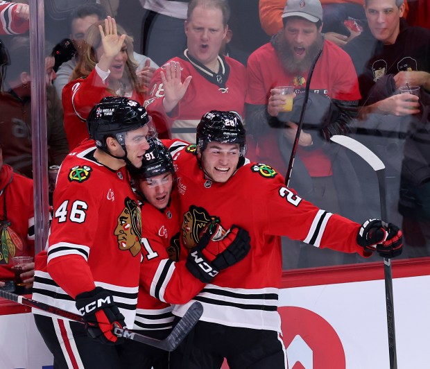 Chicago Blackhawks center Frank Nazar (center) celebrates with teammates Louis Crevier (46) and Colton Dach (right) after Nazar scored a goal in the second period of a game against the Colorado Avalanche at the United Center in Chicago on Jan. 8, 2025. (Chris Sweda/Chicago Tribune)