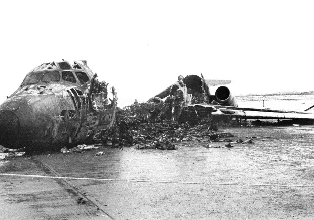 The burned out hulk of a North Central Airlines DC-9 lies on tarmac at Chicago's O'Hare Airport, Dec. 21, 1972, where it came to rest after striking the tail assembly of a Delta Airlines airplane while taking off on Dec. 20. Ten people died in the collision. The Delta plane was taxiing to the passenger terminal when it was struck by the North Central plane. (Larry Stoddard/AP)